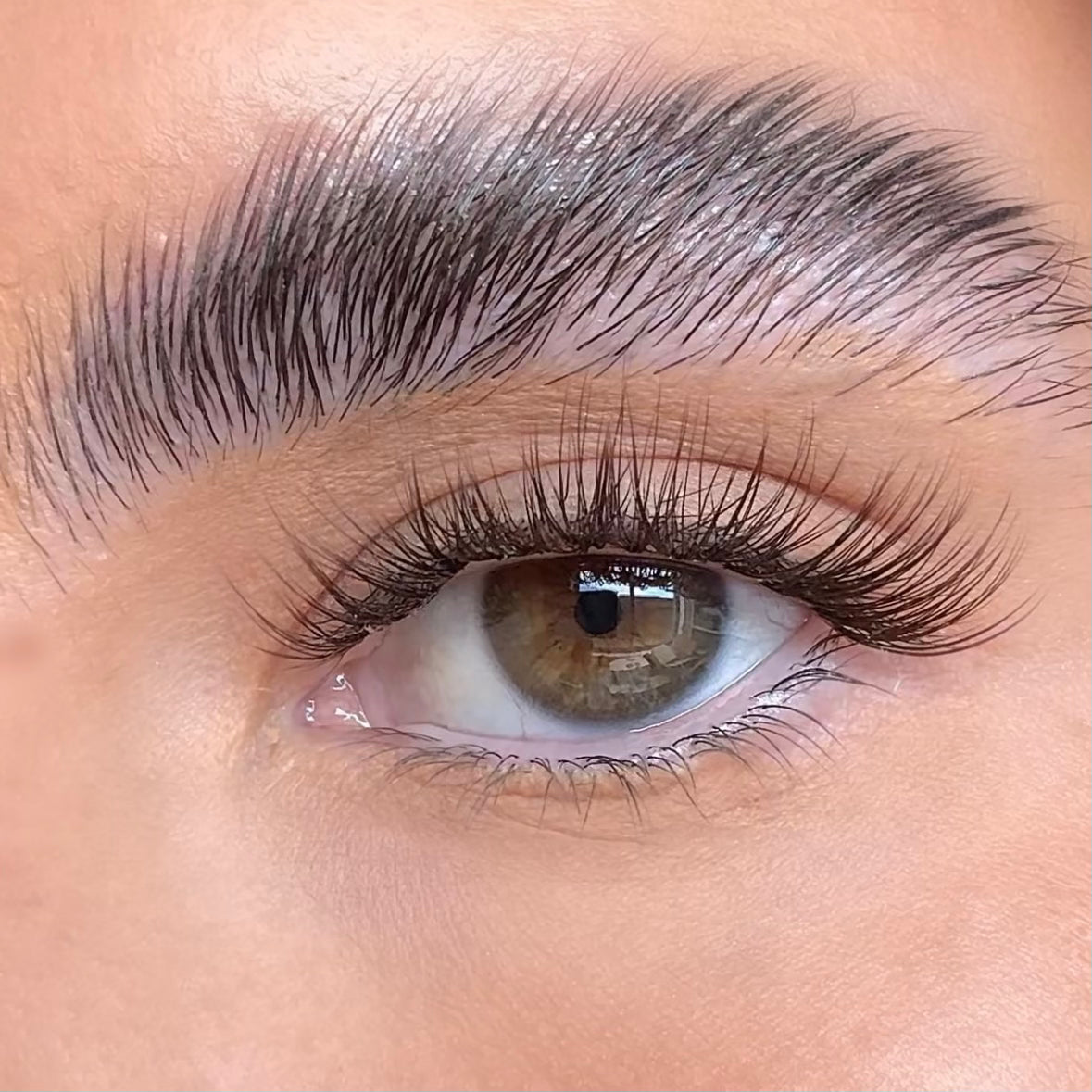 Close-up of an eye with long, dark eyelashes